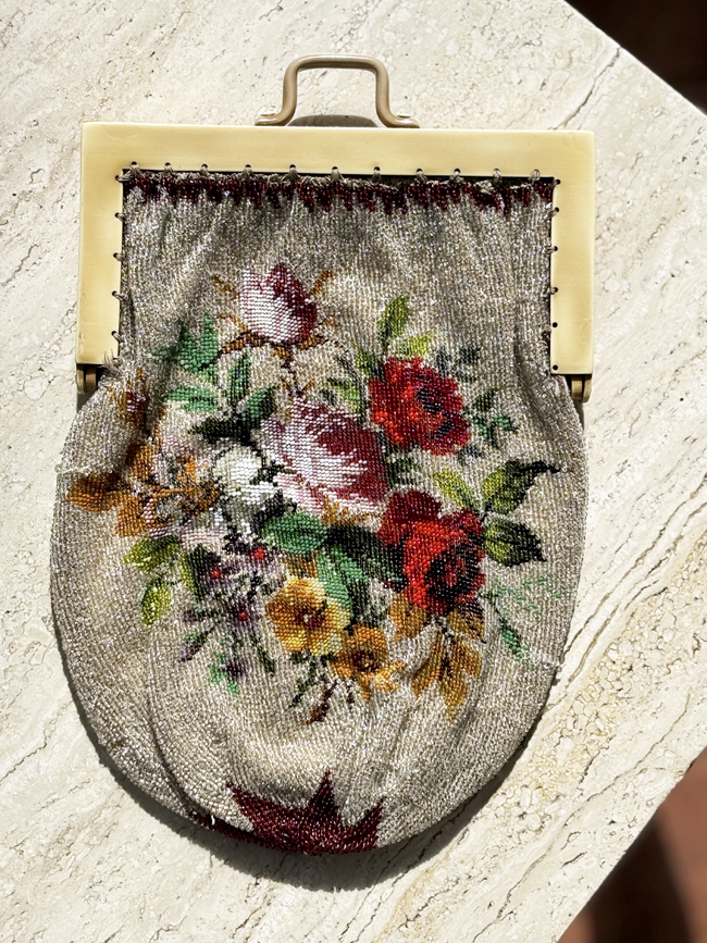 Antique beaded evening bag with floral design and celluloid handles