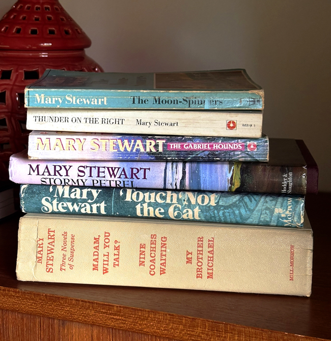 Stack of vintage books on table, all written by Mary Stewart
